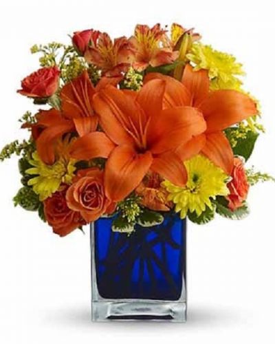 <div id="mark-3" class="m-pdp-tabs-marketing-description">Flower power rises several degrees in this brilliant array of hot summer flowers in a cool blue contemporary glass cube vase. Send this gift of indoor sunshine to someone close to you.</div>
<div id="desc-3">
<p>The radiant bouquet includes orange Asiatic lilies, orange alstroemeria, yellow cushion spray chrysanthemums, solidago and orange spray roses accented with assorted greenery.
</p></div>
