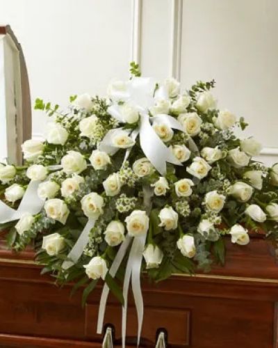 <p>Every moment spent with your loved one is a memory you want to hold onto forever. Commemorate their life with this beautiful white half casket cover, crafted by our expert florists with long-stem white roses accented with crisp greenery. Traditionally sent by the immediate family to the funeral home.</p>