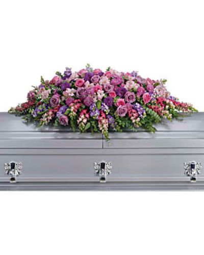 <div id="mark-1" class="m-pdp-tabs-marketing-description">Honor her femininity and generous spirit with a blanket of sweetly scented lavender, pink and purple flowers that create a magnificent final tribute, sincerely expressing devotion and love.</div>
<div id="desc-1">
<ul>
<li>Gorgeous flowers such as lavender and pink roses, pink snapdragons and alstroemeria, purple and lavender chrysanthemums. All are entwined with eucalyptus, huckleberry and ming fern.</li>
</ul>
</div>