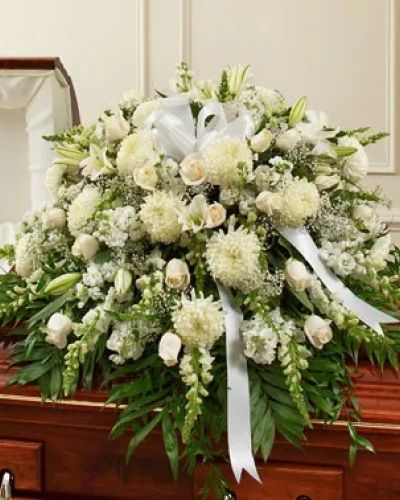 <p>Reverence. Honor. Remembrance. Peace. All of these thoughts are expressed beautifully with this elegant tribute. Crafted by our expert florists from pure white blooms such as fresh white roses, lilies, mums, snapdragons and more, it makes a beautiful final tribute. Traditionally sent by the immediate family directly to the funeral home.</p>