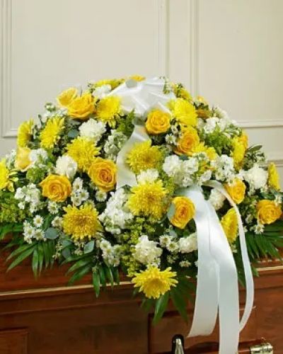 <p>This beautiful half casket cover reflects your deepest sympathies and love for a life well lived. This display features gorgeous long stem yellow roses, white cremones, carnations and more accented by crisp greenery. Traditionally sent by the immediate family directly to the funeral home.</p>