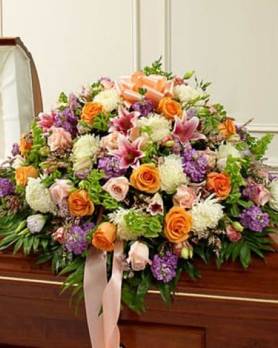 <p>Their life was filled with beauty and joy. Remember all the love and happiness they shared with this casket cover arrangement in soothing and delicate pastel shades. Our expert florists create this half casket cover with fresh pastel blooms such as long-stem roses, lilies, mums, Bells of Ireland, stock, lisianthus, heather and more. Traditionally sent by the immediate family to the funeral home.</p>