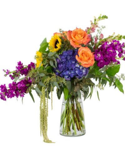 <p>The Joyful Wonder Bouquet is an artful display of vivid color that delivers joy with every glance. Featured flowers include snapdragons, stock, hydrangea, sunflowers and roses.</p>