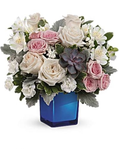 <div id="mark-3" class="m-pdp-tabs-marketing-description">Soft as a whisper, this enchanting bouquet of cream and pink roses looks oh-so-lovely in a glass cube that later becomes a comely candleholder.</div>
<p>&nbsp;</p>
<div id="desc-3">Crème roses, pink spray roses, white alstroemeria and miniature white carnations are arranged with variegated pittosporum, dusy miller, white sinuata statice and a large, potted green echeveria succulent.</div>