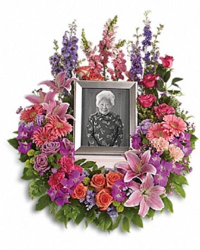 <div class="m-pdp-tabs-description">
<div id="mark-1" class="m-pdp-tabs-marketing-description">Devotion is expressed and beautiful memories cherished with this deep-hued and softly elegant wreath. A lovely reminder of your affection and respect.</div>
</div>
<p id="arrngDescp">A mix of dramatic flowers such as purple orchids and asters, orange, dark pink and lavender roses, pink and peach carnations, lavender larkspur, green chrysanthemums, and a range of pink blooms including oriental lilies, gerbers, snapdragons and more. Please note: Arrangement does not include picture frame.</p>