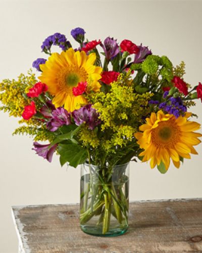<p>Summer in the Cape has all the seasons’ favorites like sunflowers, alstromerias, button pompoms and more. Crafted by an expert florist, this arrangement has bold and beautiful colors that remind you of warm days and spending time with the ones you love.</p>