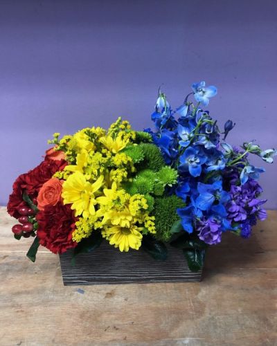 <p>This bouquet is all about capturing the color of your unique love. With a rainbow color pallete, this arrangement has everything from bold reds to vibrant violets, and the all gorgeous hues in between! Our Color of Love Bouquet is made up of a wide array of blooming beauties like carnations, roses, button pompons and more.</p>