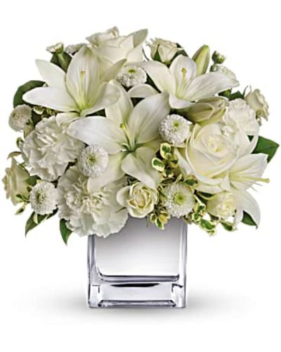 <p>This exquisite all-white bouquet in a dazzling mirrored silver cube may be petite, but it will make a huge impression.<br />
So much beauty for such a merrily modest price tag.<br />
The lovely bouquet includes white roses, white spray roses, white Asiatic lilies, white carnations and white button spray chrysanthemums accented with assorted greenery.</p>